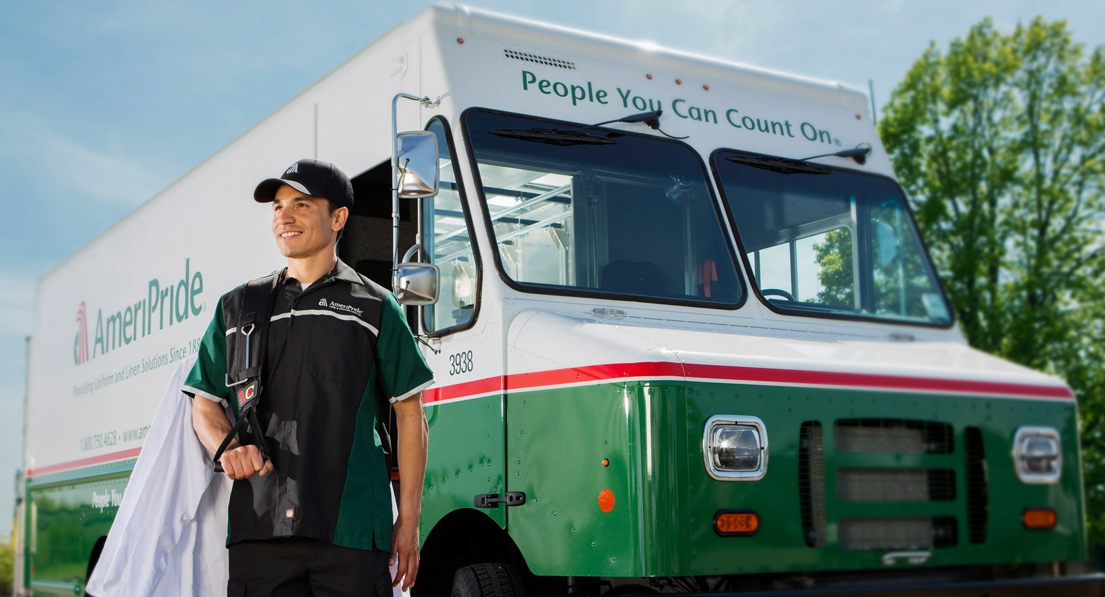 AmeriPride truck with employee standing beside it